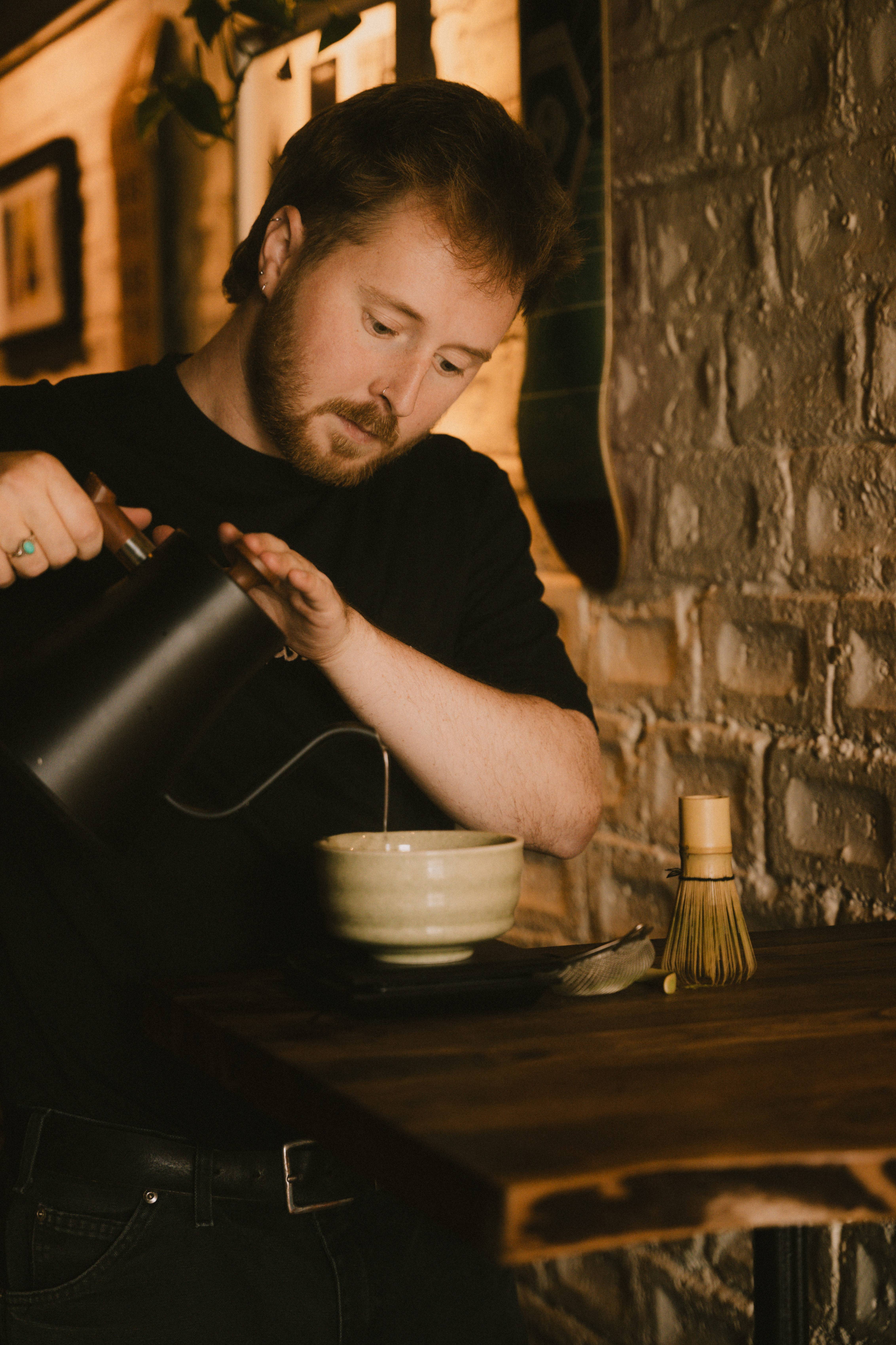 Reece making coffee behind the bar